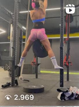 Atleta professionista che esegue trazioni con pesi e cintura per dip