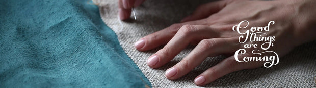 Close-up of hands working on fabric with 'Good Things are Coming' text overlay