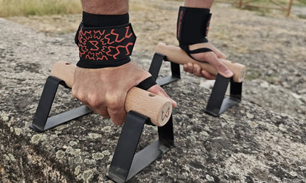 Person using parallettes wearing wrist wraps of wild dynamics