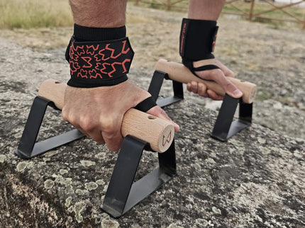 Person using parallettes wearing wrist wraps of wild dynamics