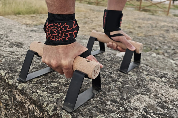 Person using parallettes wearing wrist wraps of wild dynamics