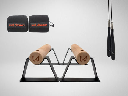 Wild Dynamics workout equipment including resistance bands, wooden parallettes and jump rope.