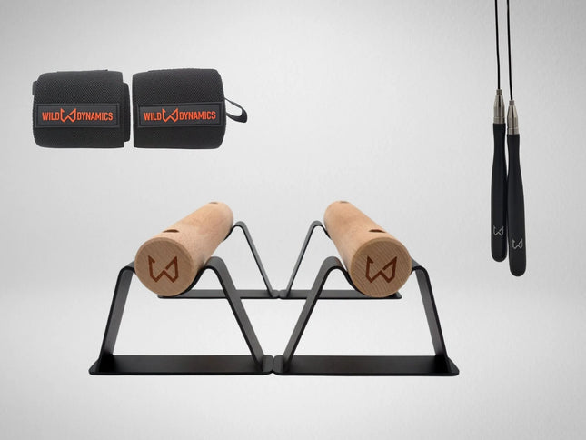 Wild Dynamics workout equipment including resistance bands, wooden parallettes and jump rope.