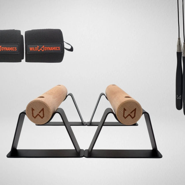 Wild Dynamics workout equipment including resistance bands, wooden parallettes and jump rope.