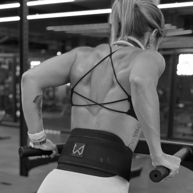 Person exercising with resistance bands in a gym setting