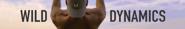 Calisthenics athlete doing front lever on rings outside wearing wild dynamics hat with logo. 