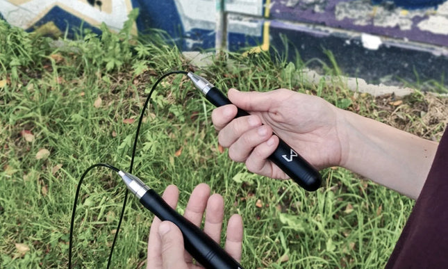Person holding a jump rope with graffiti in the background