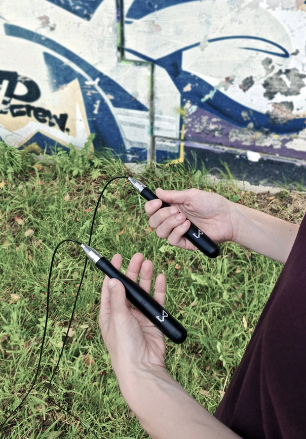 Person holding a jump rope with graffiti in the background