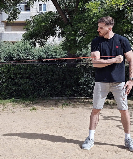 Athlete exercising with resistance bands of wild dynamics outside