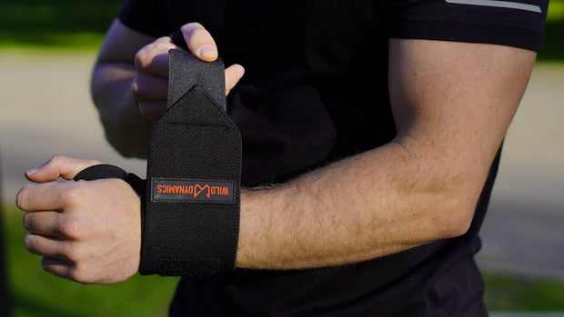 Athlete putting on wrist wraps of wild dynamics