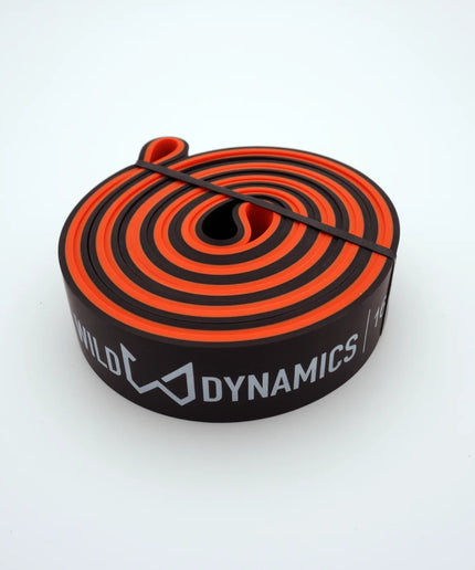 Black and orange resistance band with 'Dynamics' branding on a white background