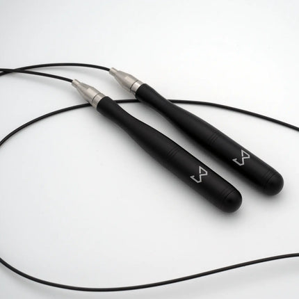 Black jump rope with silver ends on a white background