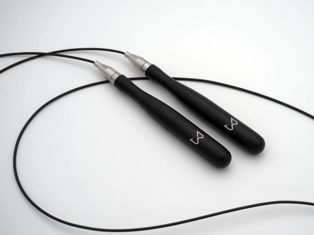 Black jump rope with silver ends on a white background