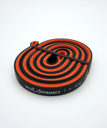 Black and orange resistance band with 'Wild dynamics' branding on a white background