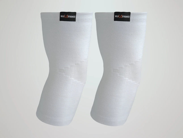 Pair of white elbow sleeves with visible branding on a light gray background