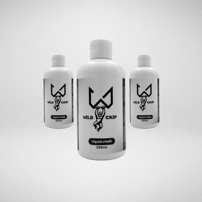 Three bottles of Wild liquid chalk on a light gray background