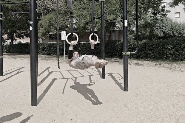 Athlete doing front lever on rings of wild dynamics