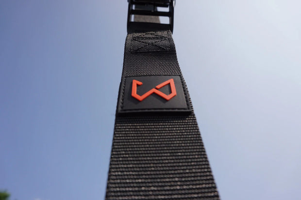 Black strap with a red logo of wild dynamics